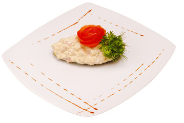 Russian traditional salad Olivier with parsley isolated on white background top view
