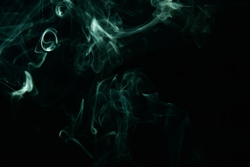 Obraz premium Green incense smoke on a black background