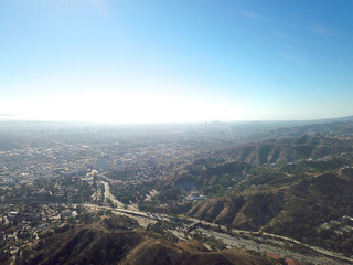 Aerial view of Hollywood valley and Los Angeles city. During blue sunny summer day. Los Angeles, California, USA.
