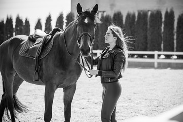 Obraz premium Girl with a horse, countryside place, woman talking to her horse. Portrait of riding horse with woman at rancho 