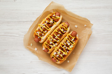 Homemade Detroit style chili dog on parchment, view from above. Top view, overhead, flat lay....