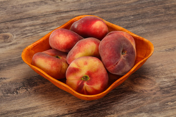 Fototapeta na wymiar Sweet ripe tasty flat peach