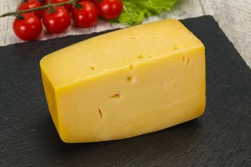 Hard yellow tasty cheese brick