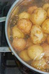 New potatoes boil in their skins in a saucepan