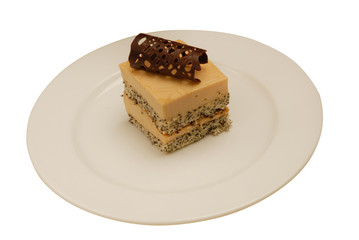 Slice of delicious coconut cake on a white plate on white isolated background
