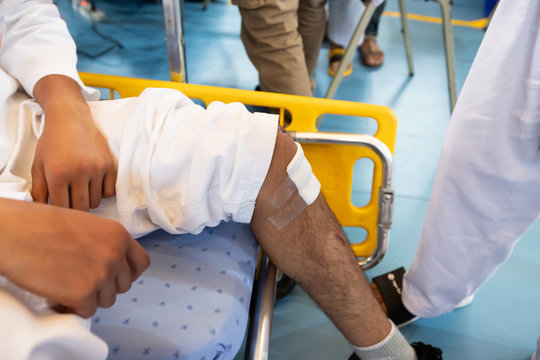 Nurse EMS put Ice pack on hand  and foot of injured player to treatment wound pain who punch to fighter in sport event competition