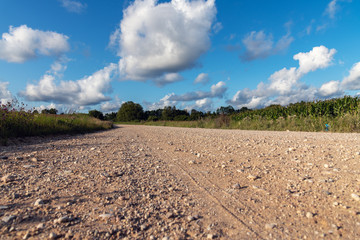 Gravel countryside road in summer afternoon.