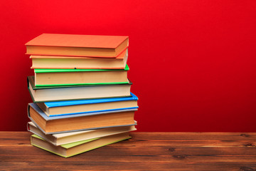  pile of old books, panorma, good copy space  on red background