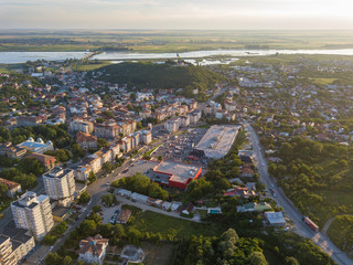 Fototapeta na wymiar Aerial view of Slatina city and river Olt, Romania. Drone flight over the european city in summer day.