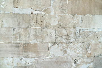 background old gray stone wall polished. repaired seams between stones. Rectangular concrete blocks. Copy space.