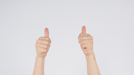 Male's hand doing two thumbs up sign on white background.