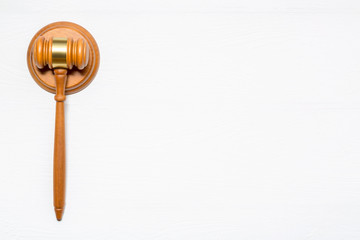 Wooden judge gavel hammer on white wooden table background. Copy space