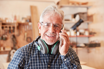 Craftsman with mobile phone at customer service