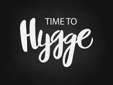 Vector illustration of hygge text for logo. Handwritten brush lettering for banner, logo, flayer, label, icon, badge, sticker. White isolated inscription on black chalkboard.