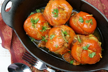 Tomatoes stuffed with a spicy mixture of mashed potatoes in an Indian gravy or curry.