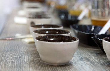 Naklejka na ściany i meble Tasting coffee in glass, Coffee cups on table for tasting..