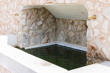 stone fountain with water pipes