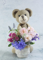 Teddy bear doll with flower bouquet