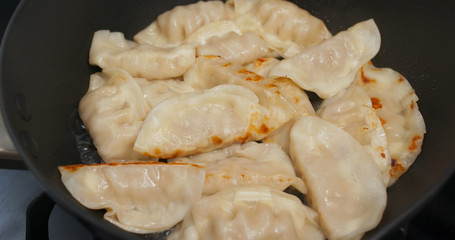 Fry meat dumpling on pan in kitchen