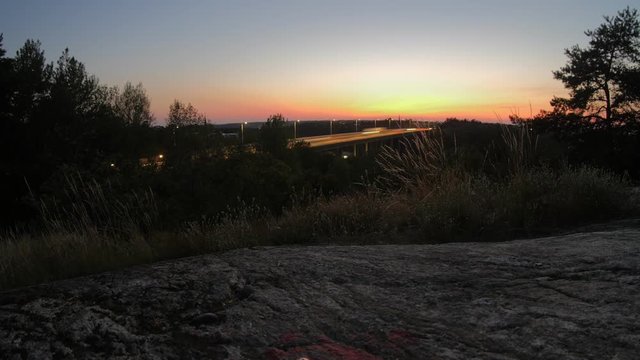 Time lapse of a sunset captured on a hill in Liljeholmen in Stockholm facing the motor highway Essingeleden.