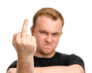 Aggressive man with blurred face showing fuck off sign with the middle finger isolated white...