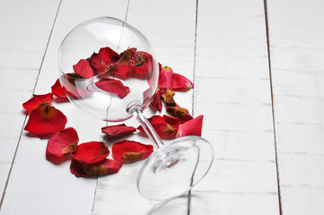 Fototapeta na wymiar Wine glass and beautiful red rose isolated on white background