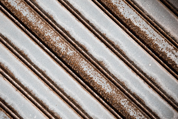 Abstract background - diagonal close-up of rusty metal shutter