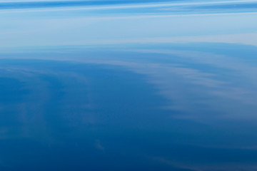 Water surface. View of a Crystal clear sea water texture. Landscape. Small waves. Water reflection