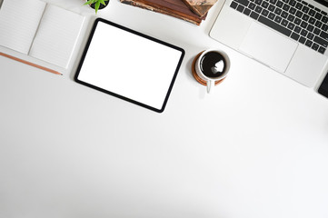 Mockup digital tablet on office desk with copy space top view table.