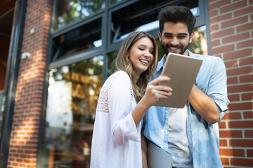 Young couple using a digital tablet together and smiling