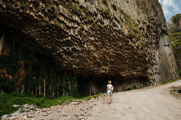 in armenia garni in the valley the antique organ basalt columns unique geological formation. Girl...