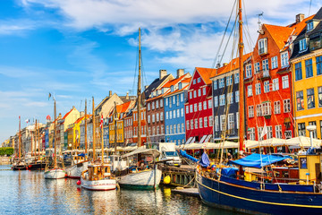 Copenhagen iconic view. Famous old Nyhavn port in the center of Copenhagen, Denmark during summer...