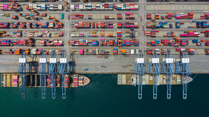 Fototapeta na wymiar Aerial view cargo ship terminal, Unloading crane of cargo ship terminal, Aerial view industrial port with containers and container ship.