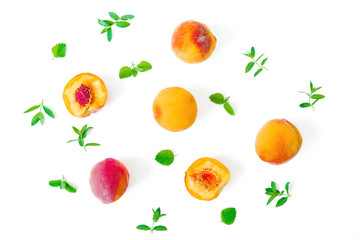 Ripe peaches with leaves isolated on white background. Fruit pattern. Top view. Flat lay