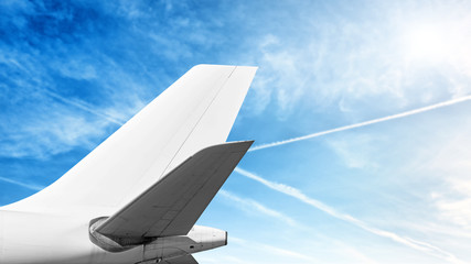 modern airplane tail isolated on cloud sky background side view of commercial passenger jet...