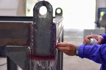 Workers use cleaner for remove the penetrant from the welding of structure.This is second step of...