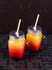 Tequila sunrise coctktails served in jars