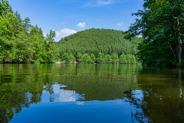 Fototapeta na wymiar Lake surrounded by mountains and forests