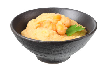 black bowl with chickpea hummus isolated on white background