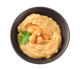 black bowl with chickpea hummus isolated on white background