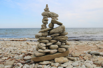 Cairn on seashore and sky on a summer day