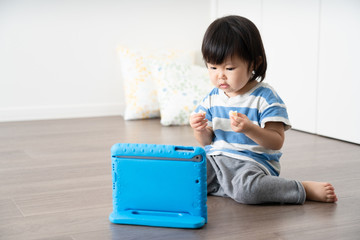 タブレットパソコンで動画を見る子供