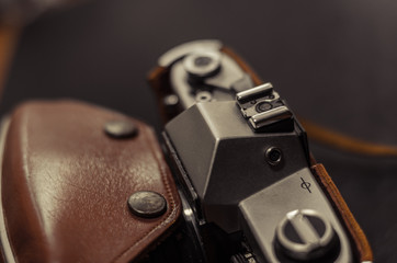 Vintage camera thick leather case side view. Macro. Soft focus.