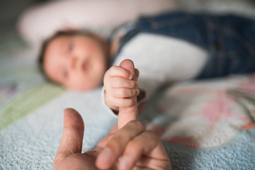 Son holds father by the hand. close-up. Closeup of a senior man and girl holding hands