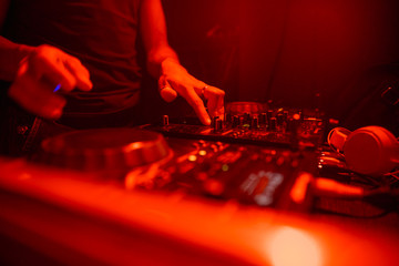 DJ playing music on light background