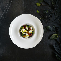 Exquisite Serving White Restaurant Plate of Black Risotto with Octopus, Cuttlefish or Squid Meat...