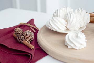 Marshmallow on a plate, white meringue marshmallow background. Flat lay. View from above. Berry sweet homemade marshmallows on a wooden stand. Traditional Russian white homemade marshmallows.