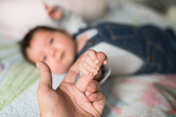 Son holds father by the hand. close-up. Closeup of a senior man and girl holding hands