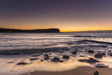Soft Dawn Seascape and Rocks on the Shore