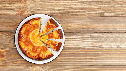 Homemade Pineapple Upside Down Cake on wooden table. Top view. Copyspace.